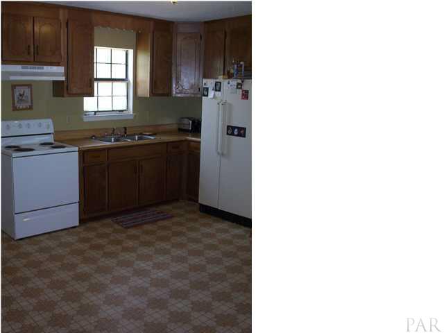 6380 Brickyard Road Molino, FL 32577 - Photo 3 of 17 What a spacious kitchen and a window for the one who washes dishes! Electric stove and side by side refrigerator convey in the sale!