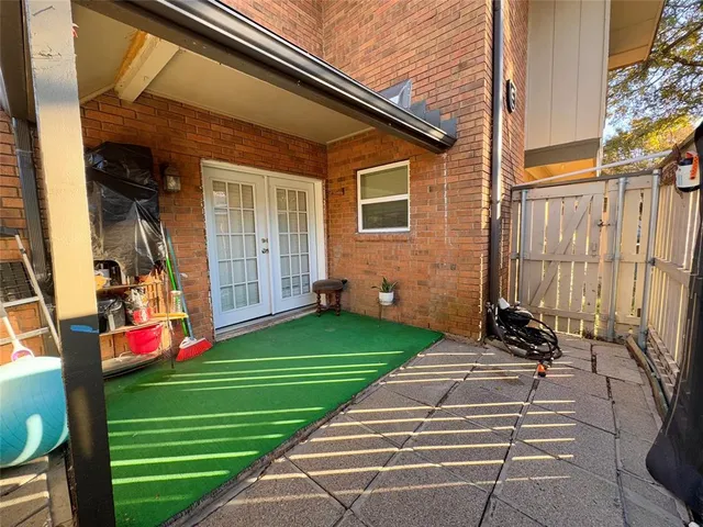 a view of a patio with swimming pool and sitting area