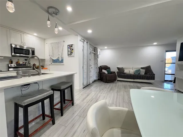 a kitchen with stainless steel appliances granite countertop a refrigerator and a stove top oven