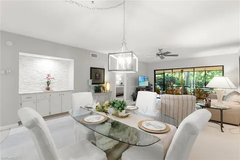 a living room with furniture and a dining table