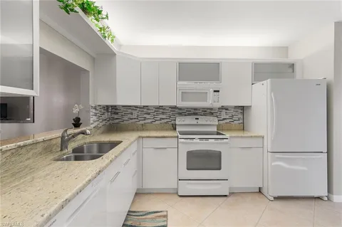 a kitchen with a sink a stove and refrigerator