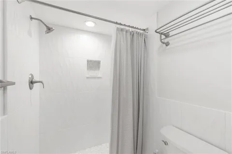 a bathroom with a shower and a shower
