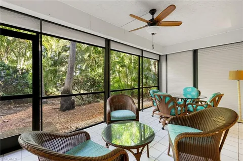 a dining room with furniture water view and wooden floor