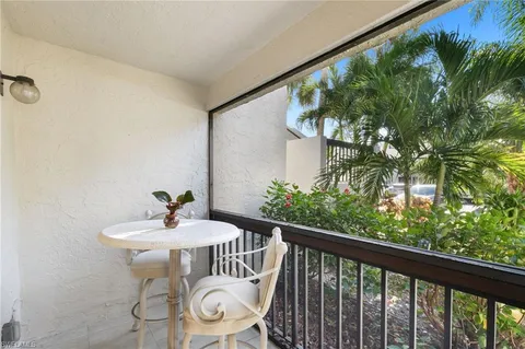a view of a balcony with a table and chairs