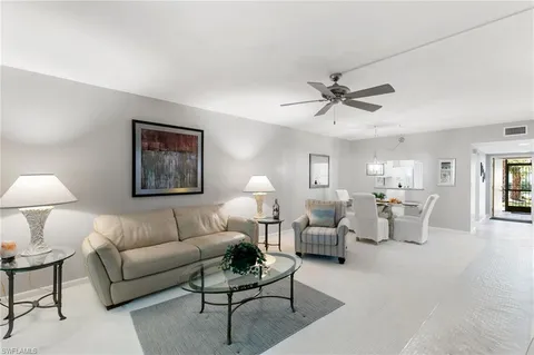 a living room with furniture and a lamp