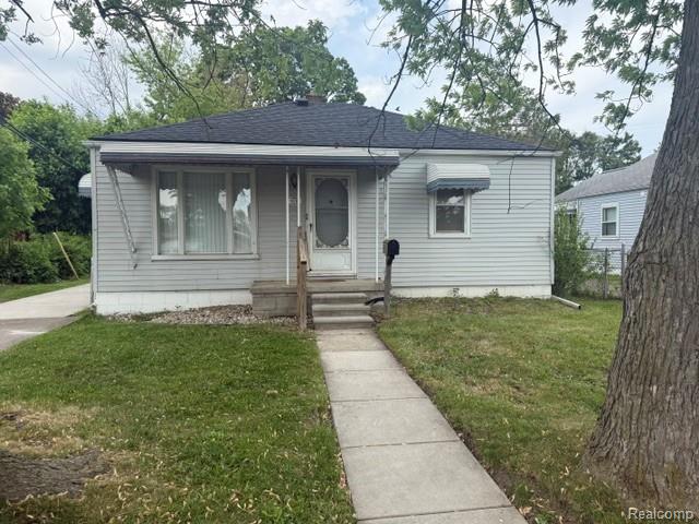 970 Champaign Road Lincoln Park, MI 48146 - Photo 1 of 28 Bungalow-style house featuring a front lawn, a shingled roof, and covered porch