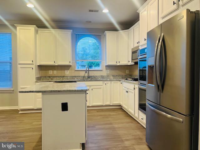 3135 Floating Leaf Lane Waldorf, MD 20603 - Photo 21 of 100 a kitchen with stainless steel appliances granite countertop a refrigerator sink and cabinets