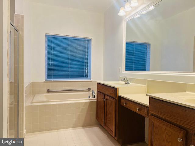 3135 Floating Leaf Lane Waldorf, MD 20603 - Photo 39 of 100 a bathroom with a sink vanity tub and a mirror