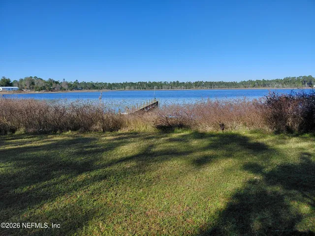 a view of a lake with houses in the background