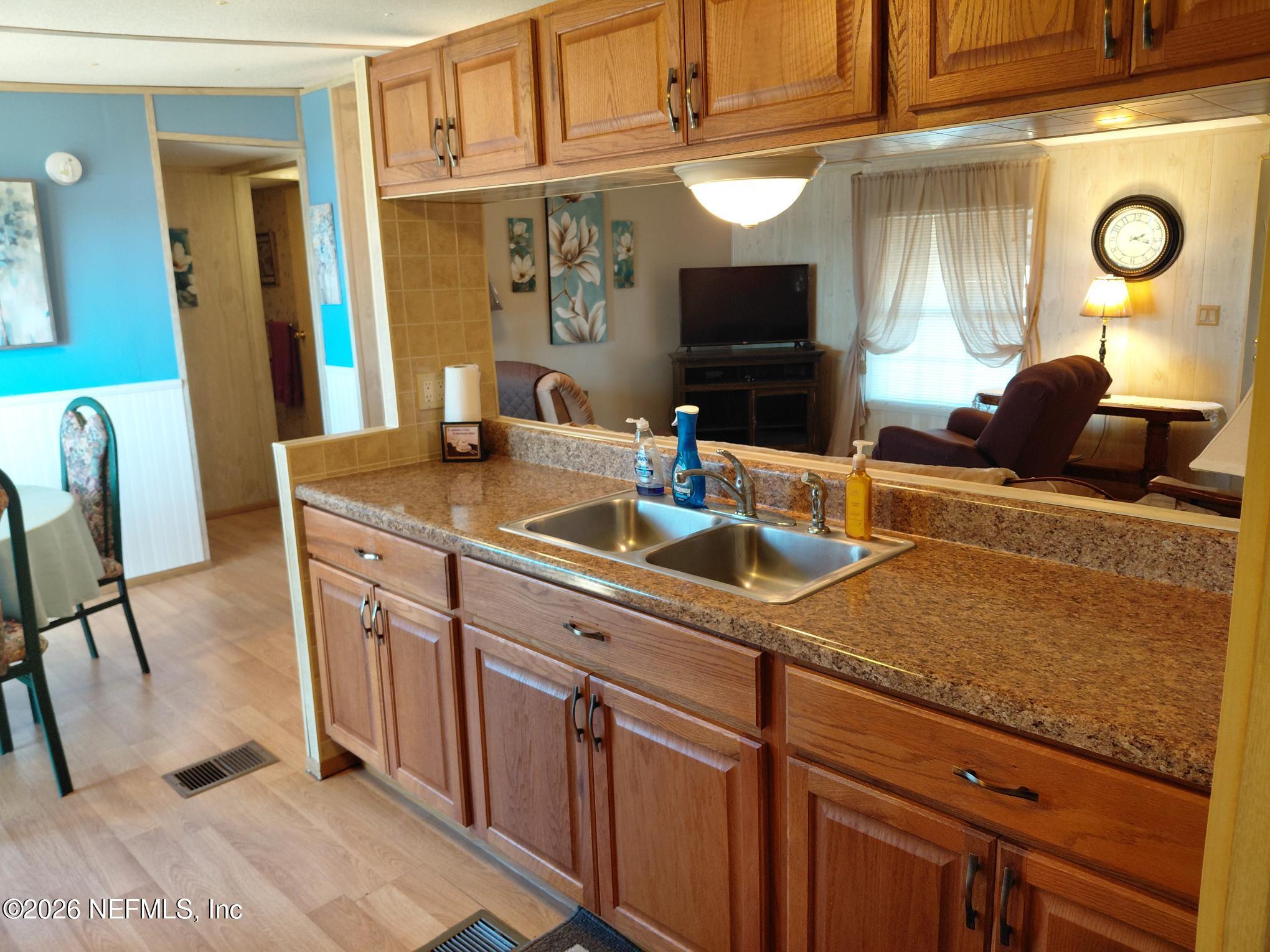 147 Jaffa Road Crescent City, FL 32112 - Photo 13 of 19 a kitchen with a sink and a refrigerator