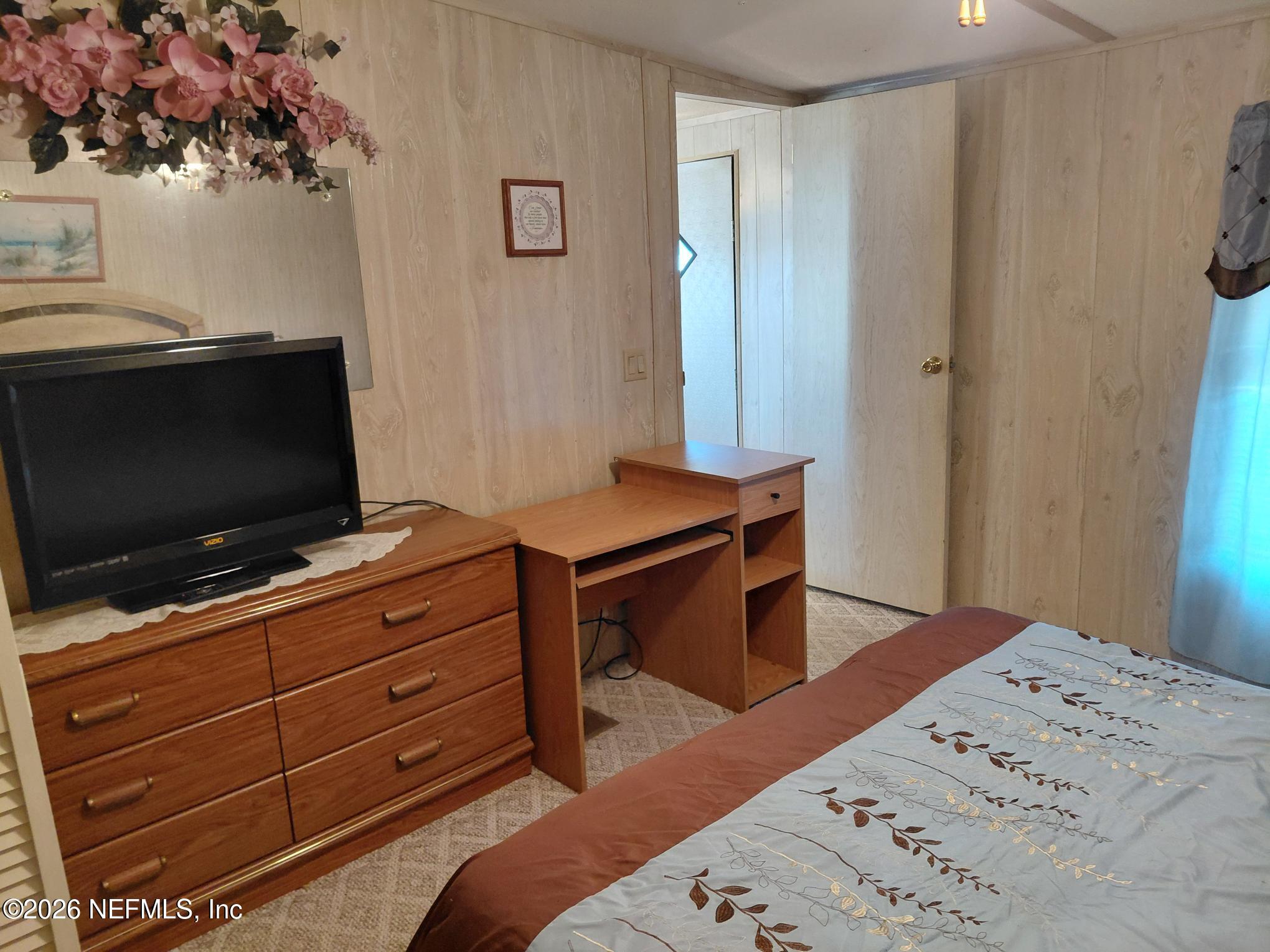 147 Jaffa Road Crescent City, FL 32112 - Photo 14 of 19 a bedroom with a bed and flat screen tv