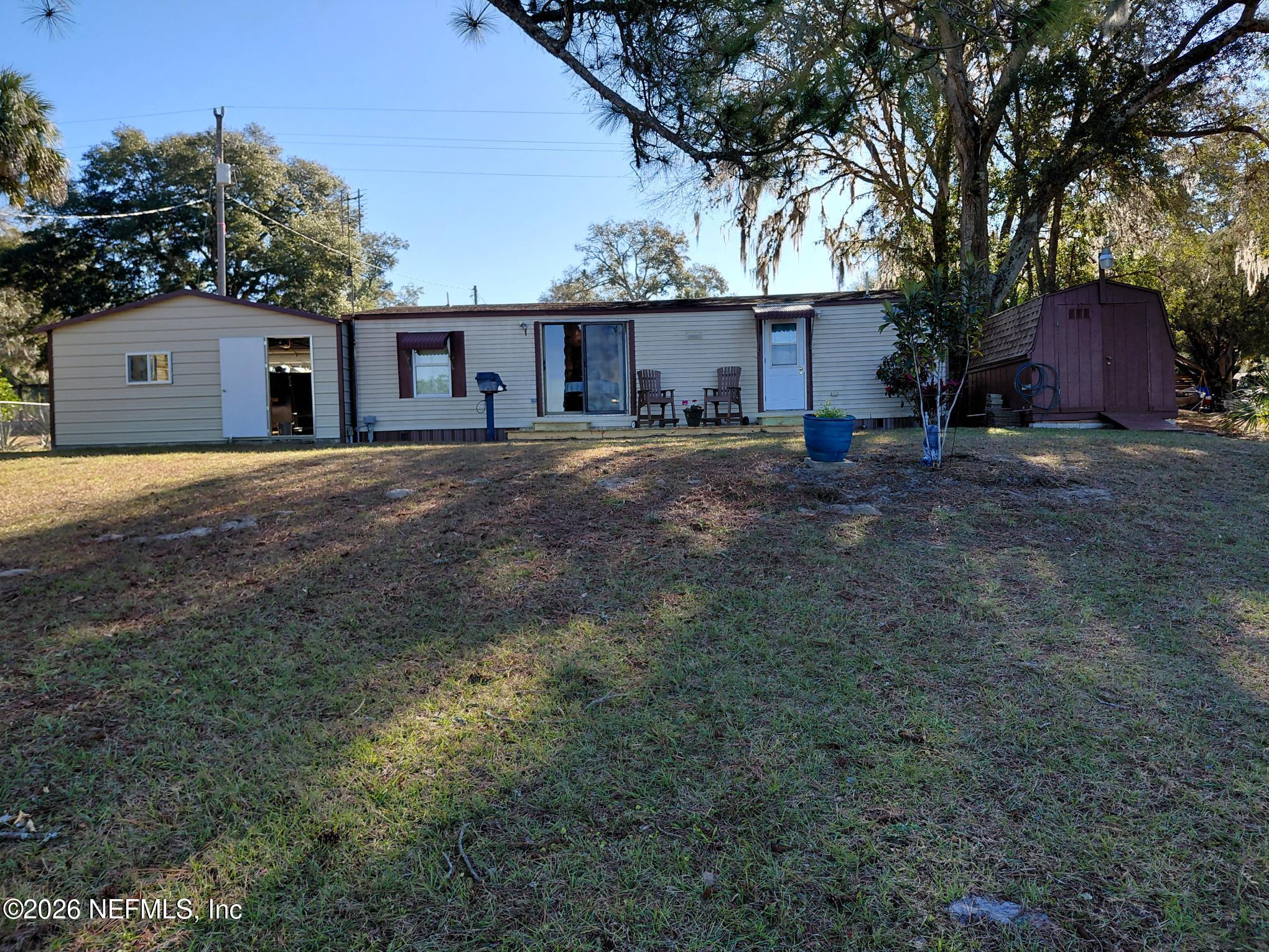 147 Jaffa Road Crescent City, FL 32112 - Photo 7 of 19 a view of a house with a yard and a large tree