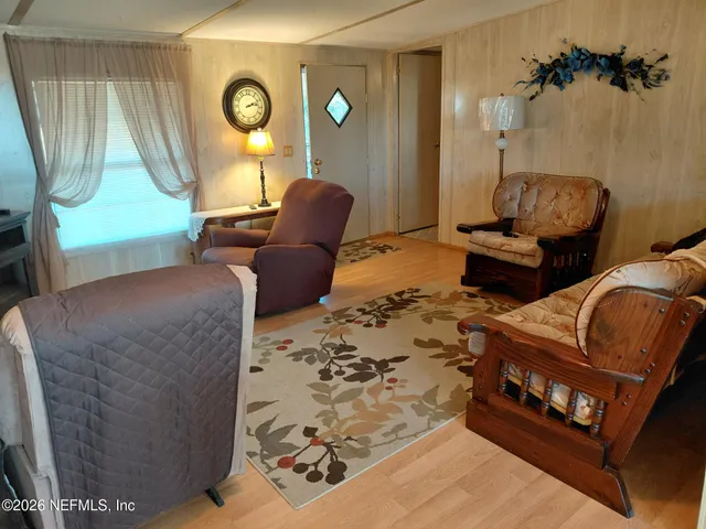 a bedroom with furniture and a lamp