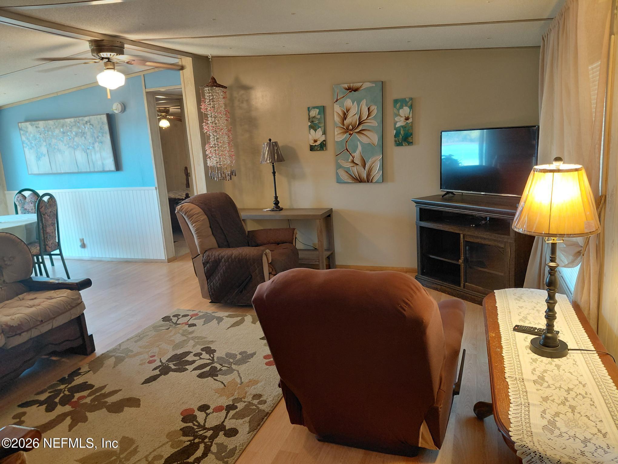 147 Jaffa Road Crescent City, FL 32112 - Photo 9 of 19 a bedroom with furniture and a lamp