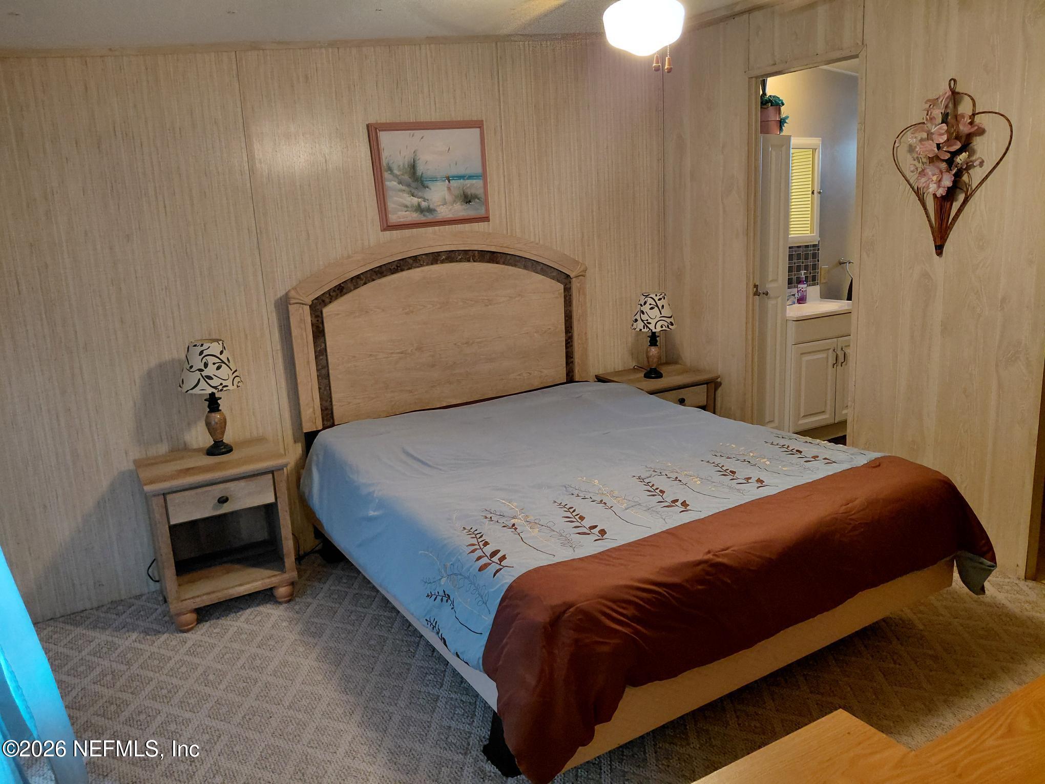 147 Jaffa Road Crescent City, FL 32112 - Photo 10 of 19 a bedroom with a bed and dresser with mirror