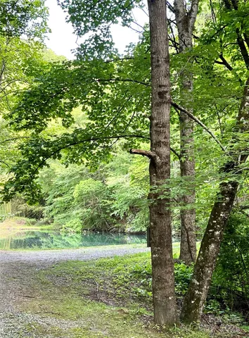 a view of roof deck with chairs and wooden fence