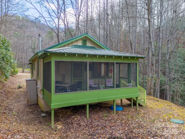a view of a chair and table in backyard of the house
