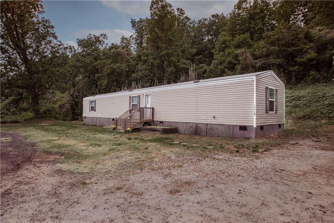 1188 Old Liberty Road Easley, SC 29640 - Photo 2 of 28 This manufactured home offers tranquil living amidst a lush, wooded backdrop, providing a peaceful escape.