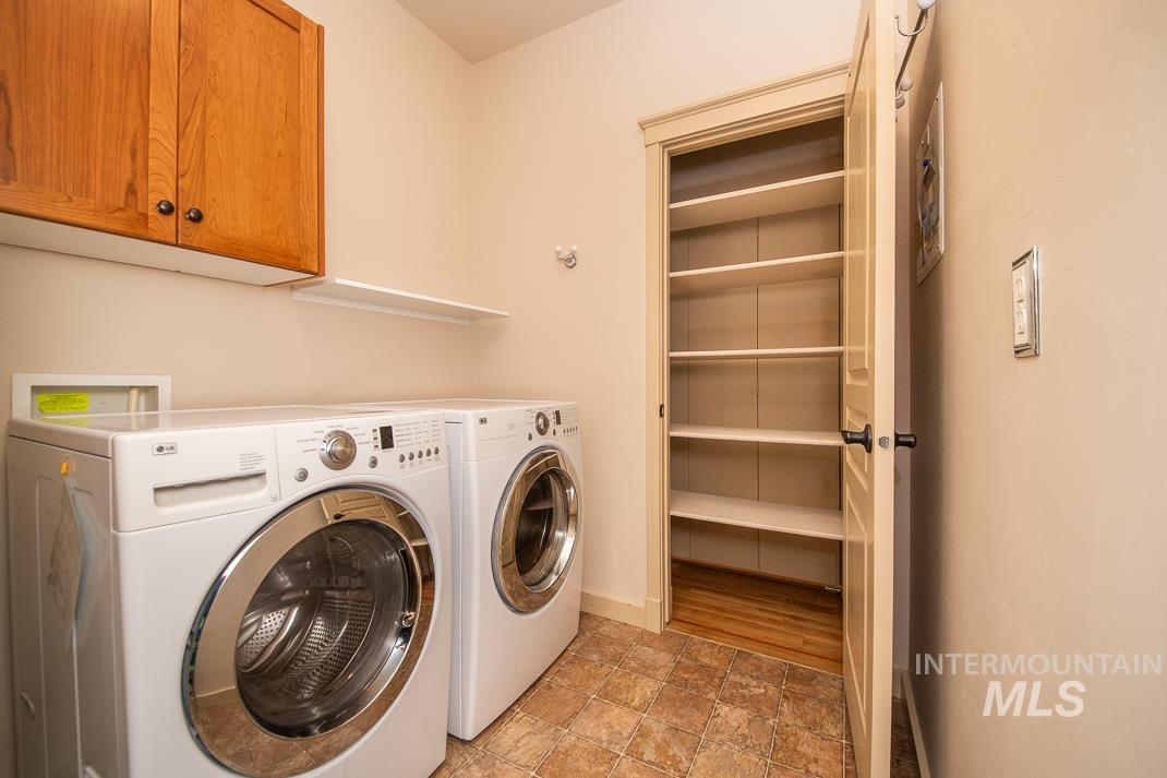727 West Sedgewick Street Meridian, ID 83646 - Photo 21 of 30 Laundry room featuring stone finish floors, cabinet space, and separate washer and dryer