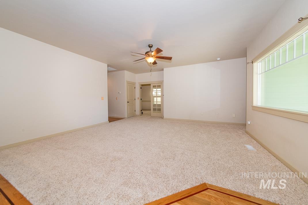 727 West Sedgewick Street Meridian, ID 83646 - Photo 9 of 30 Empty room featuring light carpet and ceiling fan