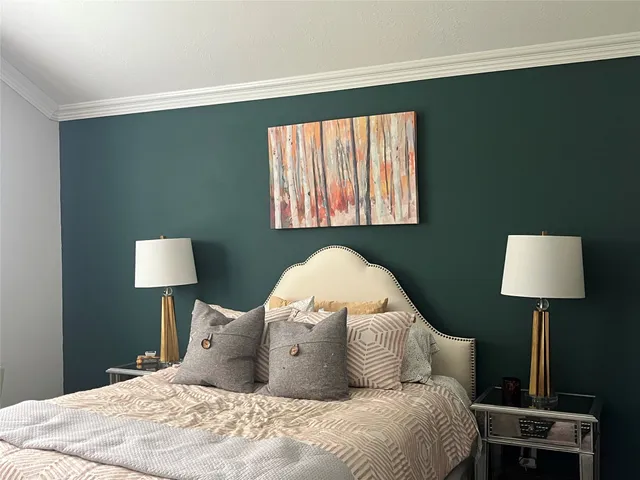 a bedroom with a bed and a lamp on table