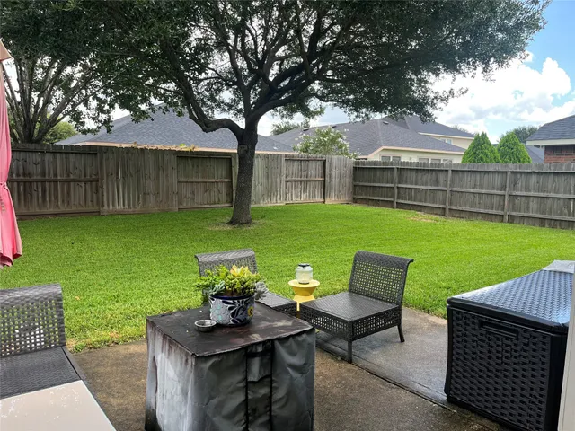 a view of a backyard with furniture and garden