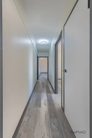 a view of hallway with wooden floor