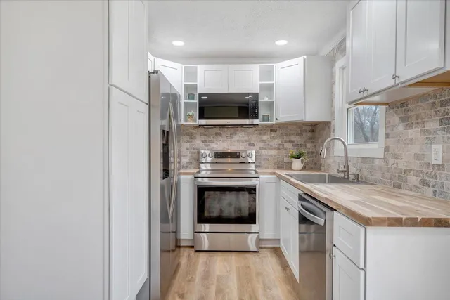 a kitchen with a sink and stainless steel appliances