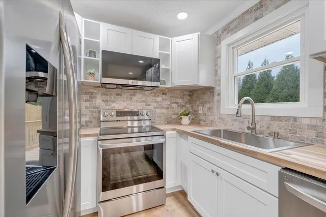 a kitchen with a sink stove and microwave