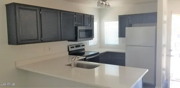 a kitchen with a refrigerator and a sink