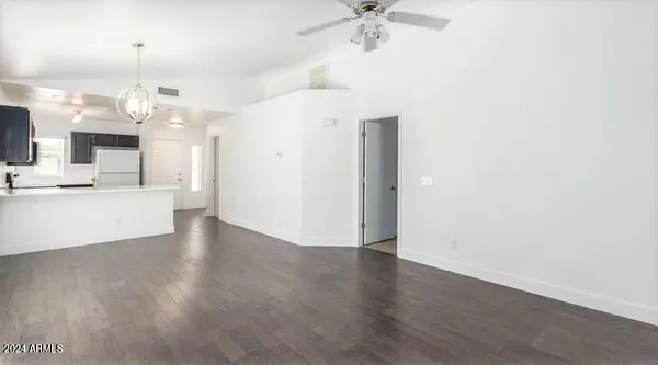 a view of a kitchen with a sink and wooden floor