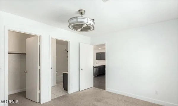 a view of a hallway with a refrigerator and a stove