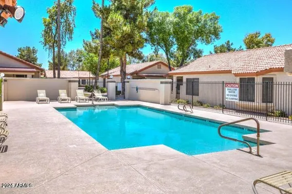a view of a house with swimming pool and sitting area