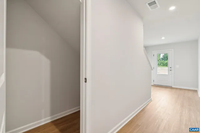 a view of hallway with wooden floor