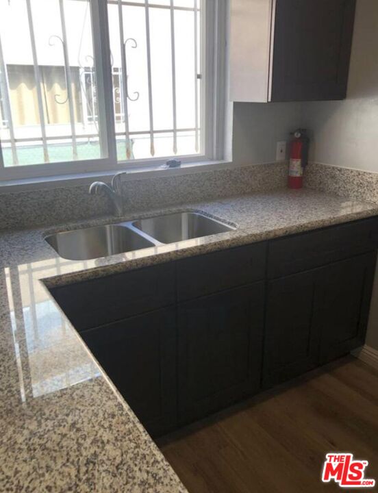 1229 West 36th Place Los Angeles, CA 90007 - Photo 7 of 8 a kitchen with a sink and a window