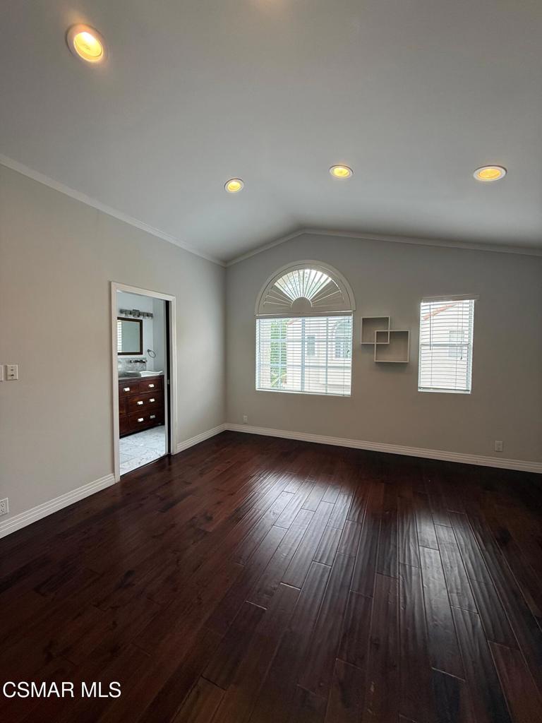 11346 Old Ranch Circle Chatsworth, CA 91311 - Photo 11 of 18 an empty room with wooden floor and windows