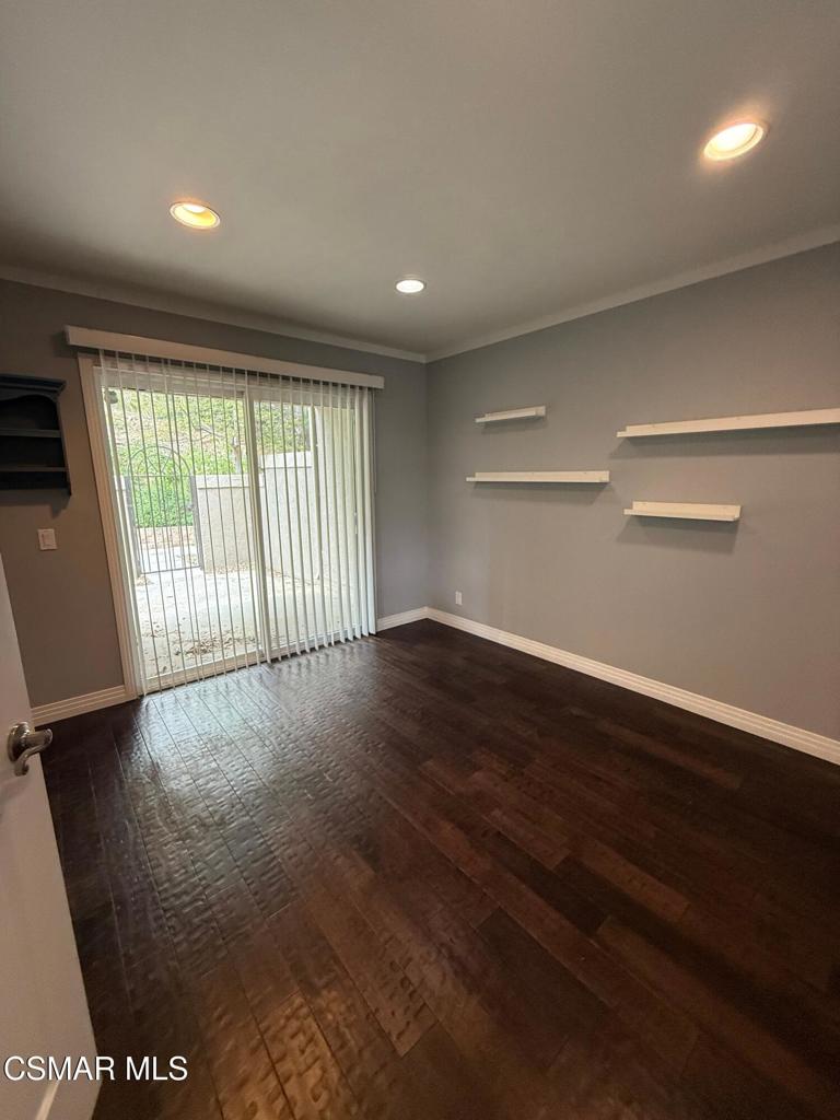 11346 Old Ranch Circle Chatsworth, CA 91311 - Photo 5 of 18 an empty room with wooden floor and windows