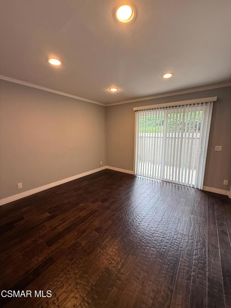 11346 Old Ranch Circle Chatsworth, CA 91311 - Photo 6 of 18 an empty room with wooden floor and windows