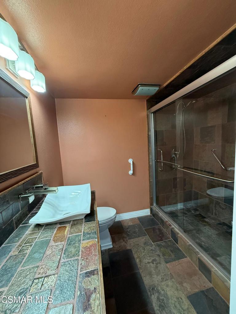 11346 Old Ranch Circle Chatsworth, CA 91311 - Photo 8 of 18 a bathroom with a toilet and a shower