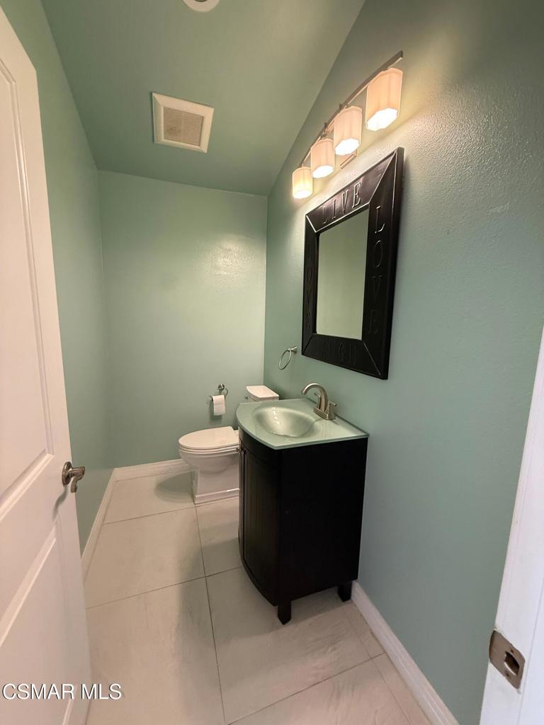 11346 Old Ranch Circle Chatsworth, CA 91311 - Photo 9 of 18 a bathroom with a toilet sink and mirror