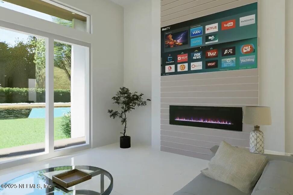 116 Longview Way North Palm Coast, FL 32137 - Photo 6 of 32 a living room with furniture a floor to ceiling window and a fireplace