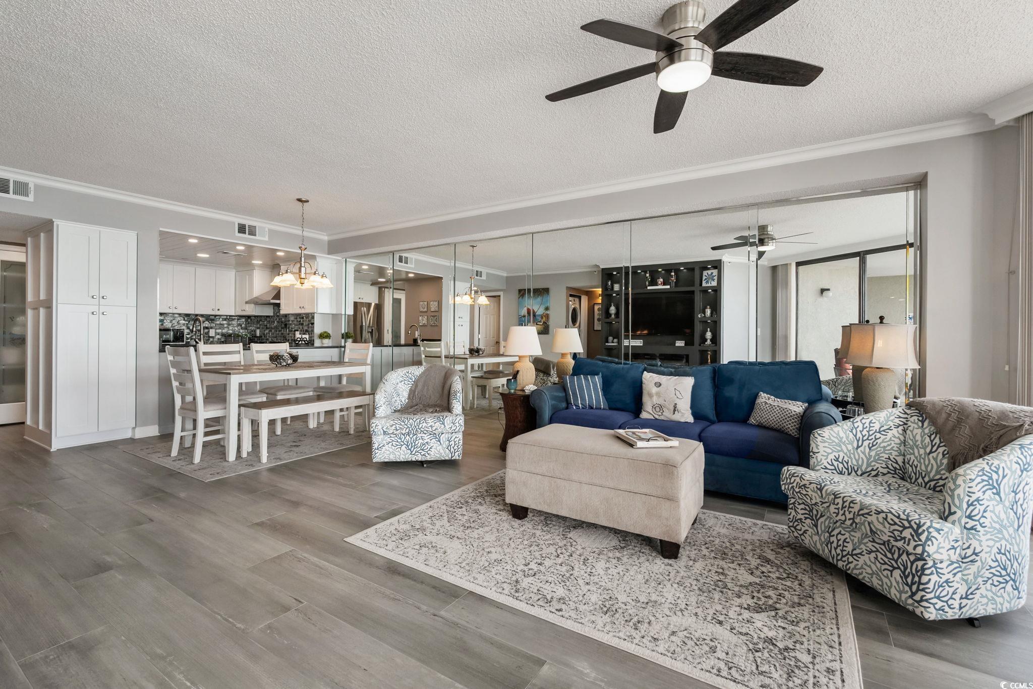 1990 North Waccamaw Drive, Unit 403 Murrells Inlet, SC 29576 - Photo 11 of 39 Living room with crown molding, a textured ceiling, wood finished floors, and a chandelier