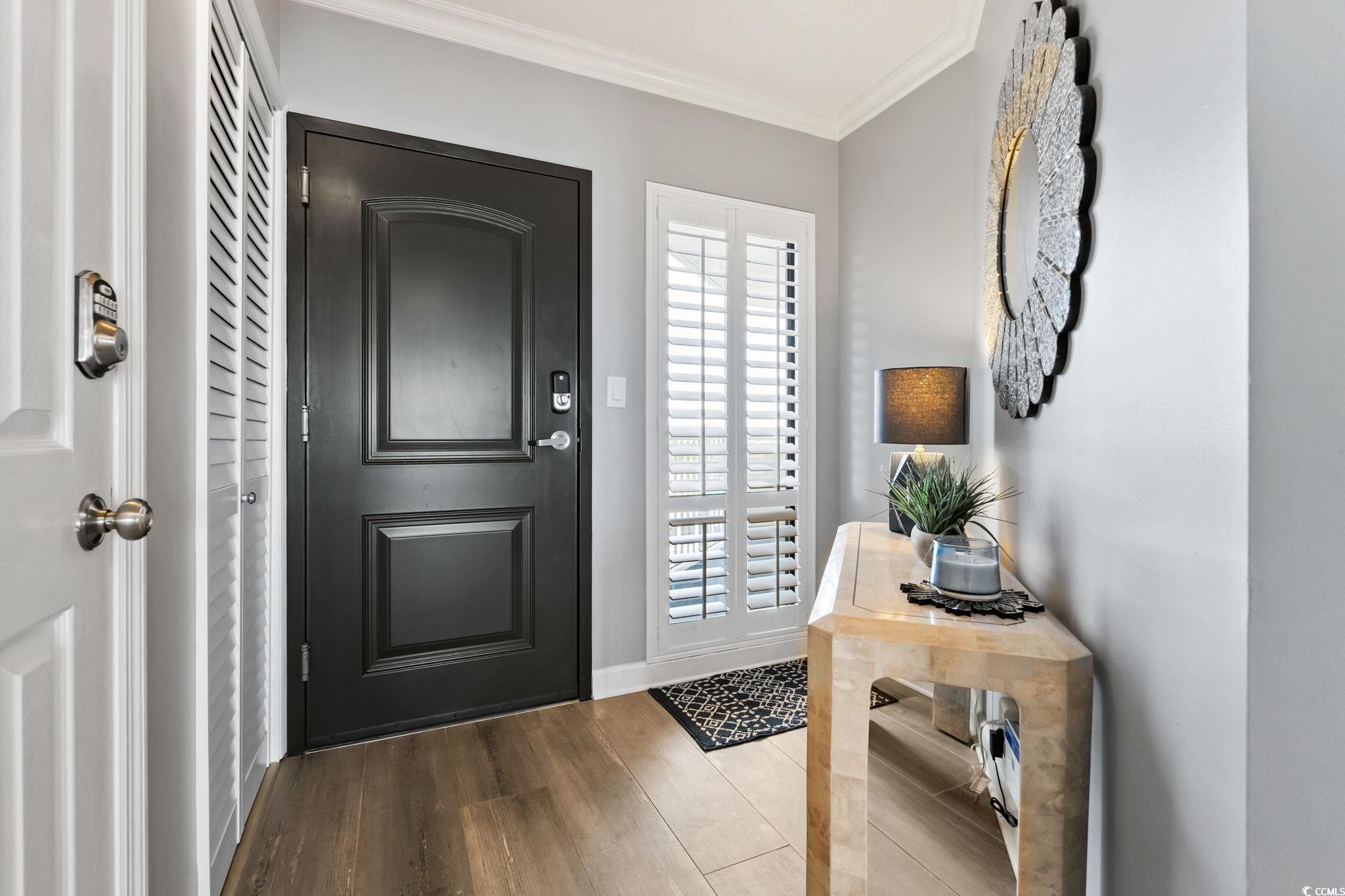 1990 North Waccamaw Drive, Unit 403 Murrells Inlet, SC 29576 - Photo 24 of 39 Foyer featuring ornamental molding and wood finished floors