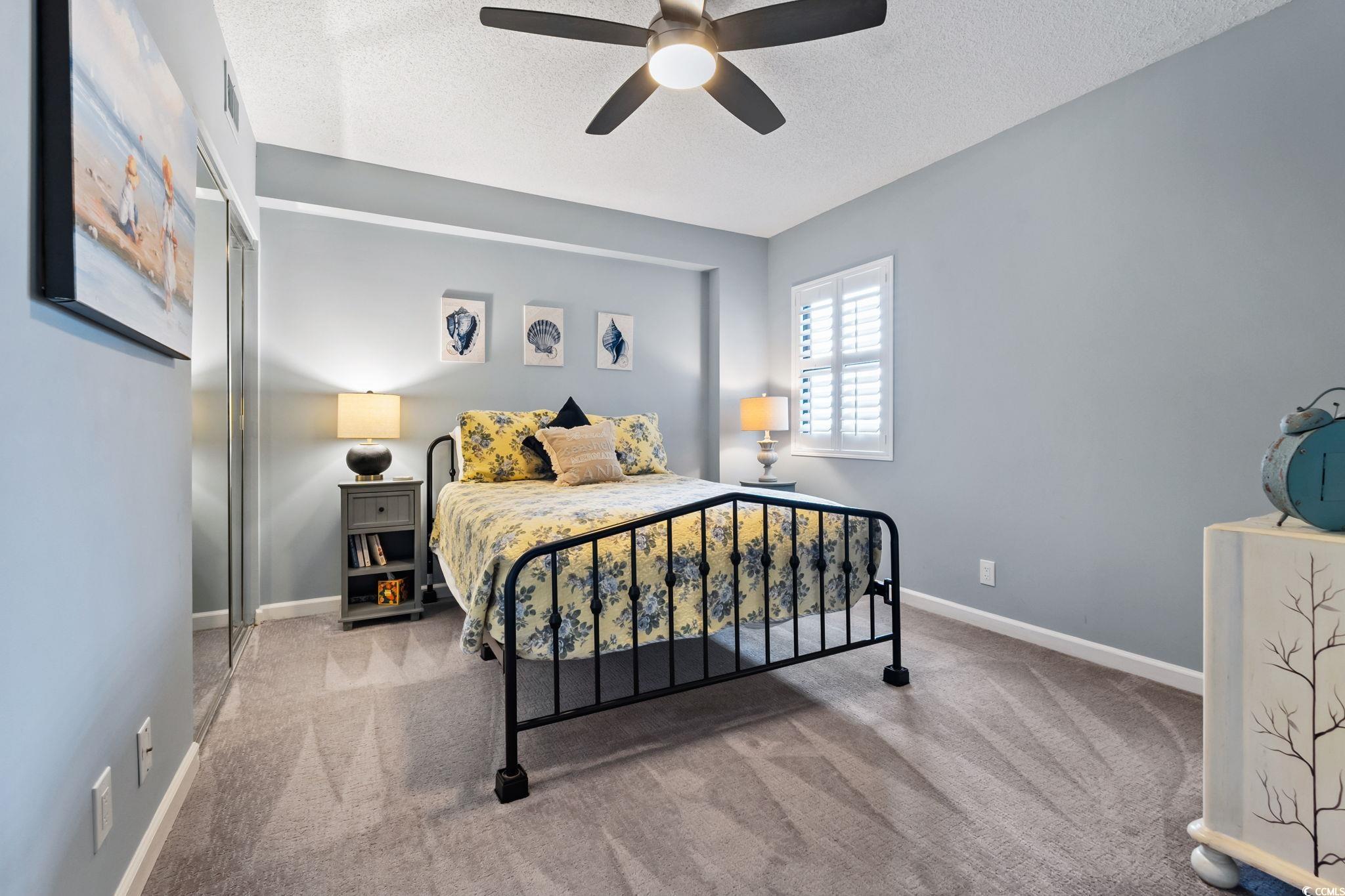 1990 North Waccamaw Drive, Unit 403 Murrells Inlet, SC 29576 - Photo 26 of 39 Bedroom with a textured ceiling, carpet floors, and a ceiling fan