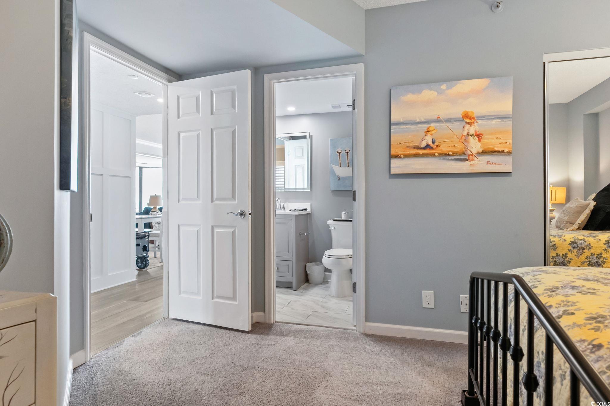 1990 North Waccamaw Drive, Unit 403 Murrells Inlet, SC 29576 - Photo 27 of 39 Bedroom with light carpet and ensuite bath