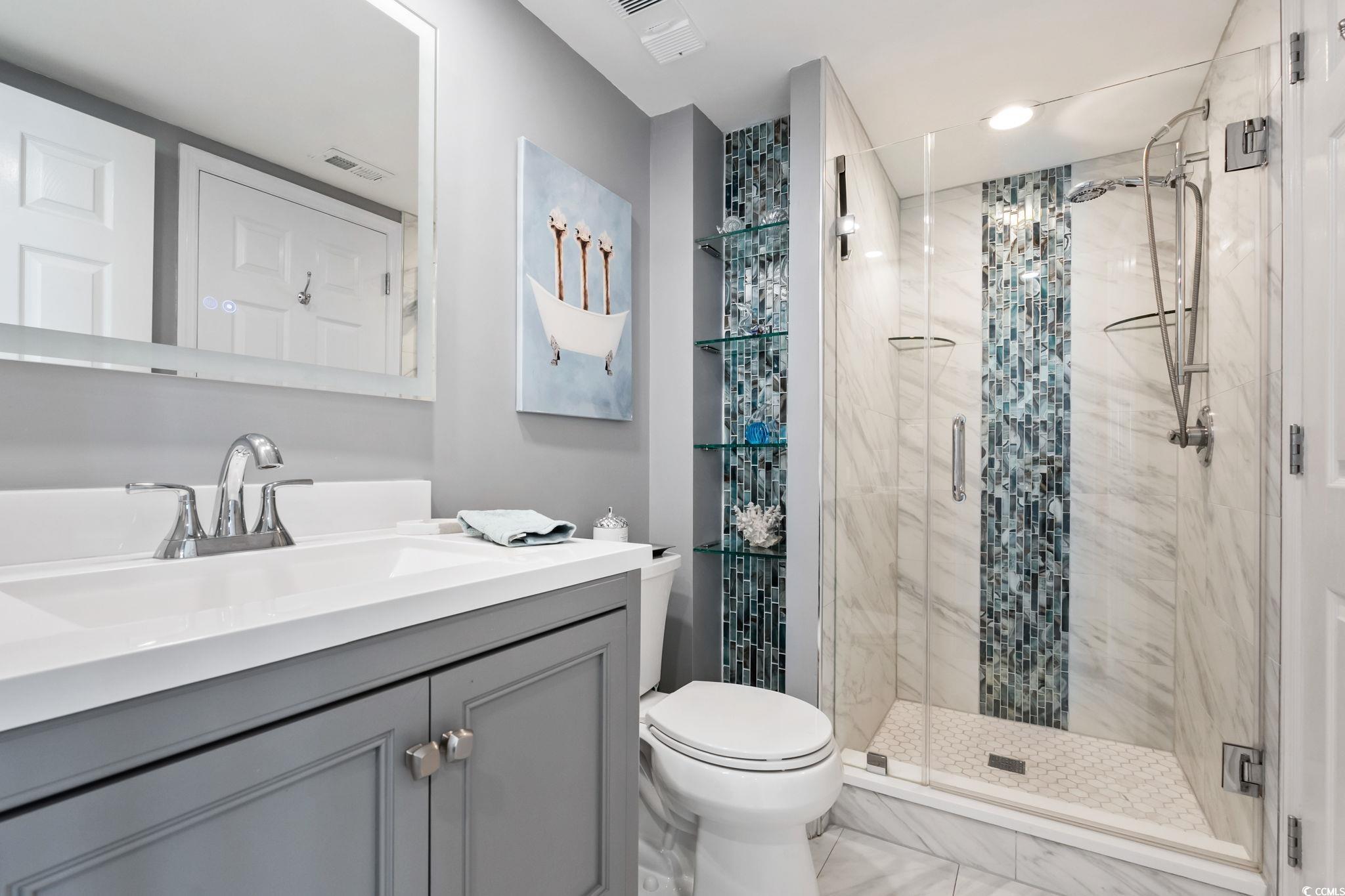 1990 North Waccamaw Drive, Unit 403 Murrells Inlet, SC 29576 - Photo 28 of 39 Bathroom with a stall shower and vanity