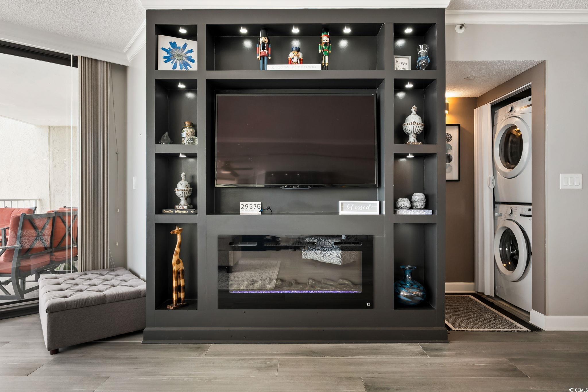 1990 North Waccamaw Drive, Unit 403 Murrells Inlet, SC 29576 - Photo 8 of 39 Bar area featuring a textured ceiling, stacked washer / drying machine, wood finished floors, and ornamental molding