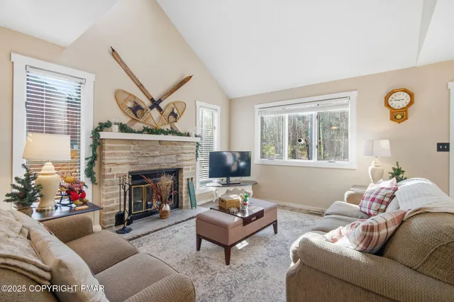 a living room with furniture and a kitchen view