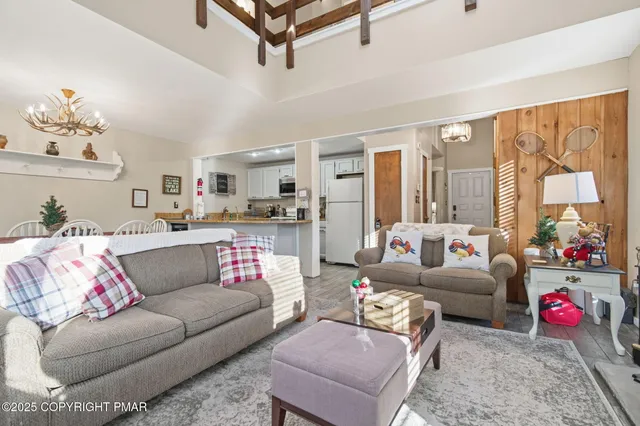 a bedroom with furniture and a large window