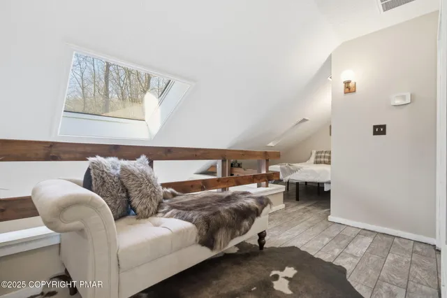 a bed sitting in a bedroom next to a window